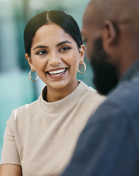 Woman smiling at colleague during work meeting