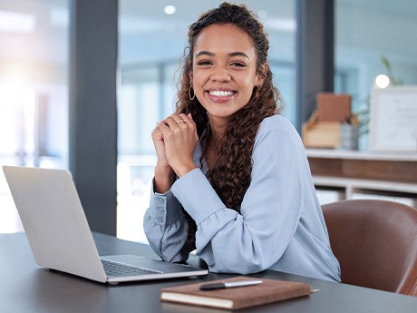 Woman smiling while working in office