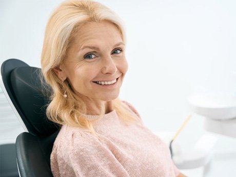 a patient smiling after receiving her dental implant restoration(s)