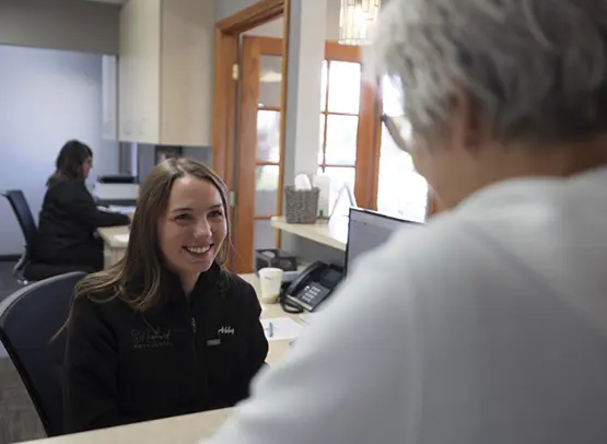Dental team member discussing dental insurance options with patient