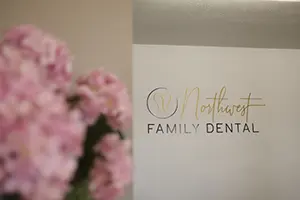 Dental patient laughing with dentist and dental team member