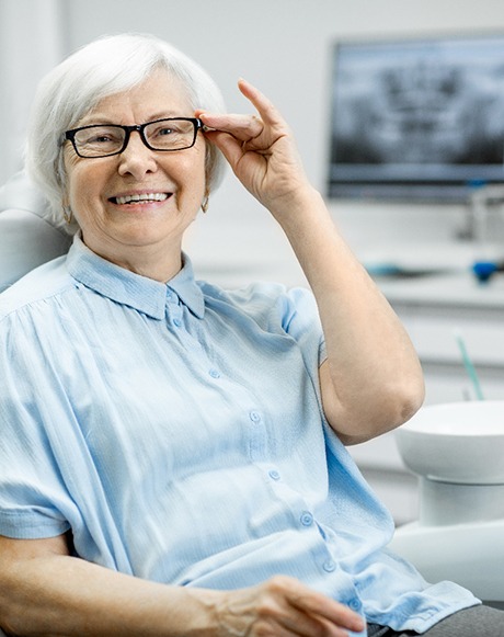 Senior woman with glasses sitting in dental chair