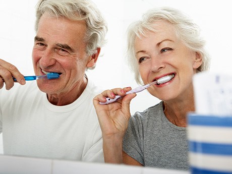 a couple brushing their teeth together