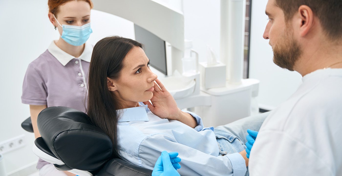 Woman with a toothache at the dentist